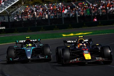 Sergio Perez (MEX) Red Bull Racing RB20 and Lewis Hamilton (GBR) Mercedes AMG F1 W15. Formula 1 World Championship, Rd 3,
