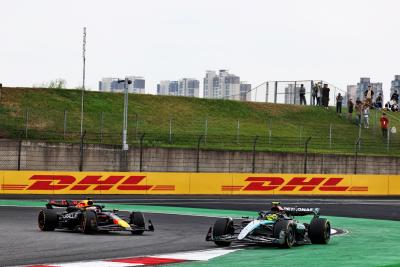 Lewis Hamilton (GBR) Mercedes AMG F1 W15 runs wide ahead of Max Verstappen (NLD) Red Bull Racing RB20. Formula 1 World