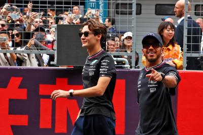 (L to R): George Russell (GBR) Mercedes AMG F1 and Lewis Hamilton (GBR) Mercedes AMG F1 on the drivers' parade. Formula 1