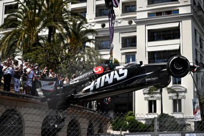 The Haas VF-24 of Kevin Magnussen (DEN) Haas F1 Team is craned from the circuit after the race stopping start crash.
