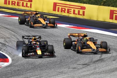 Max Verstappen (NLD) Red Bull Racing RB20 and Lando Norris (GBR) McLaren MCL38 battle for the lead of the race. Formula 1