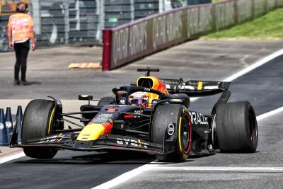 Max Verstappen (NLD) Red Bull Racing RB20 makes a pit stop with a puncture after collision with Lando Norris (GBR) McLaren
