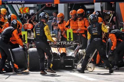 Lando Norris (GBR) McLaren MCL38 makes a pit stop with a puncture after contact with Max Verstappen (NLD) Red Bull Racing