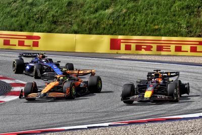 Max Verstappen (NLD) Red Bull Racing RB20 leads Lando Norris (GBR) McLaren MCL38, both with punctures after colliding.