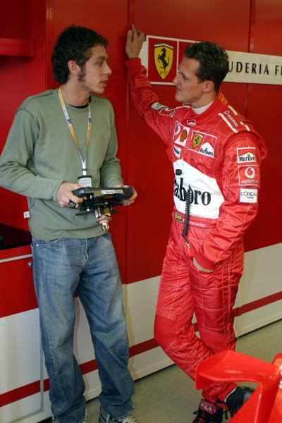 Michael Schumacher shows Moto GP superstar Valentino Rossi around the Ferrari garage at the 2004 Australian Formula One