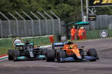 Lando Norris (GBR) McLaren MCL35M and Lewis Hamilton (GBR) Mercedes AMG F1 W12 battle for position.