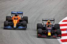 Daniel Ricciardo (AUS) McLaren MCL35M and Sergio Perez (MEX) Red Bull Racing RB16B battle for position.