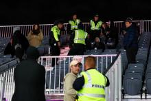 Police eject fans from the grandstand
