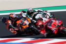 Jack Miller dives under Johann Zarco, chasing Francesco Bagnaia. 2024 San Marino MotoGP