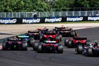 Sergio Perez (MEX) Red Bull Racing RB19 and Valtteri Bottas (FIN) Alfa Romeo F1 Team C43 at the start of the race. Formula