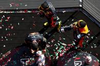 Max Verstappen (NLD) Red Bull Racing retrieves his broken trophy on the podium with Sergio Perez (MEX) Red Bull Racing and