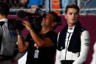 (L to R): Jean Michel Tibi (FRA) FOM Camera Operator with Logan Sargeant (USA) Williams Racing on the grid. Formula 1