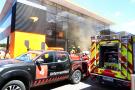 A fire in the McLaren motorhome is tended to by fire fighters. Formula 1 World Championship, Rd 10, Spanish Grand Prix,